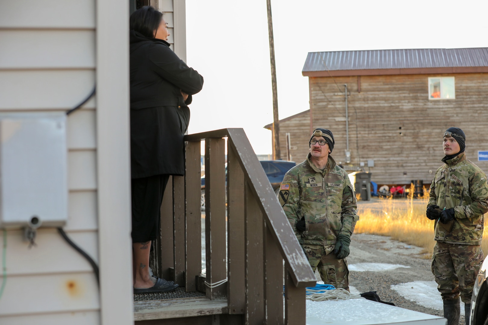 Members of the Alaska Organized Militia assigned to Joint Task Force Kotzebue speak to homeowners during damage assessments in the Arctic Circle community of Kotzebue Oct. 26, 2024. The assessments will help local emergency managers determine supplies needed to repair and rebuild structures impacted by severe flooding along Alaska’s West Coast.
