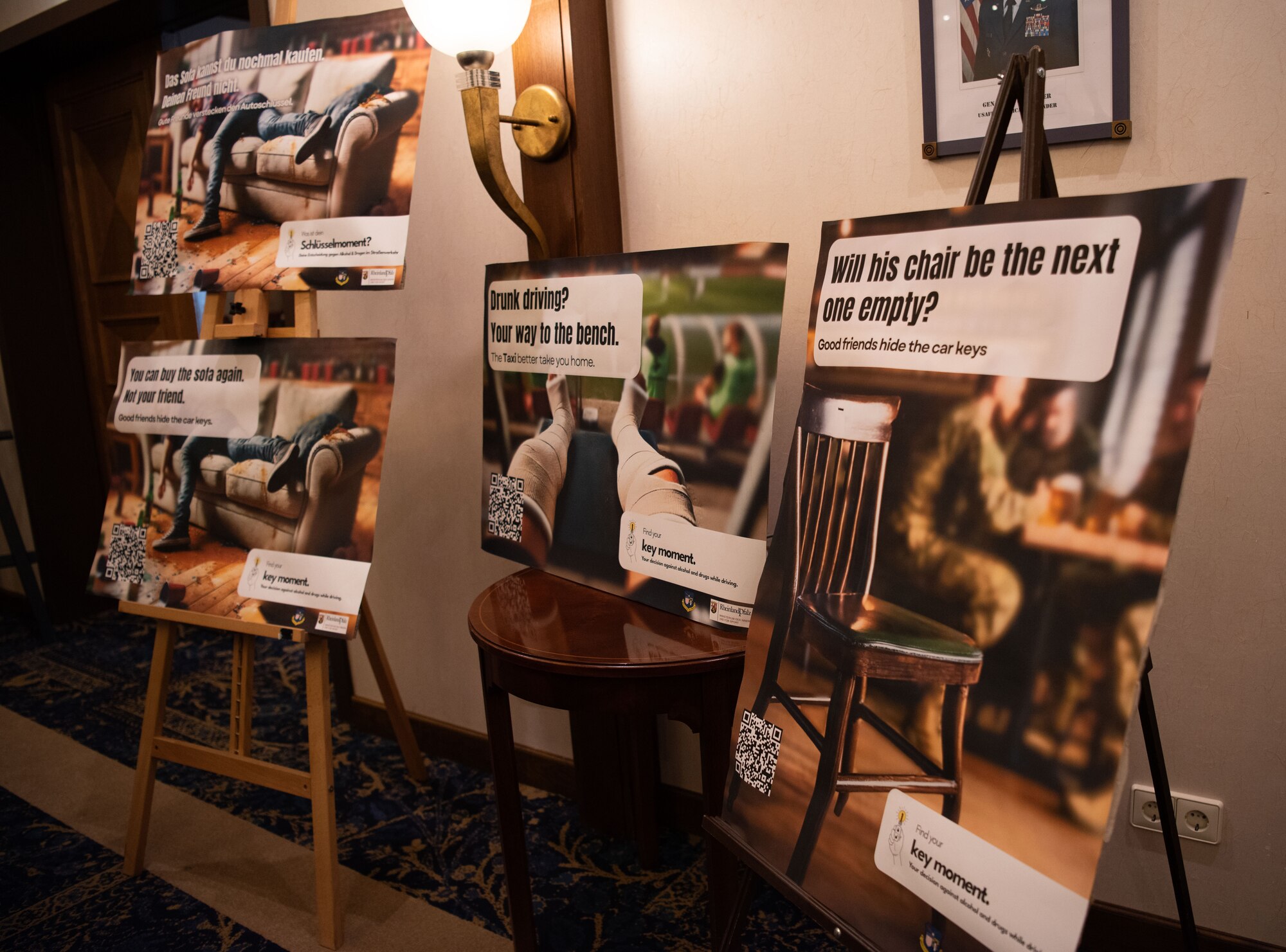 “Key Moment” DUI campaign posters are unveiled during a meeting with U.S. Air Force Maj. Gen. Paul D. Moga, Third Air Force and Kaiserslautern Military Community commander, and Jacquelin Schröder, Head of Police Inspection Pirmasens, at Ramstein Air Base, Germany, Oct. 28, 2024.