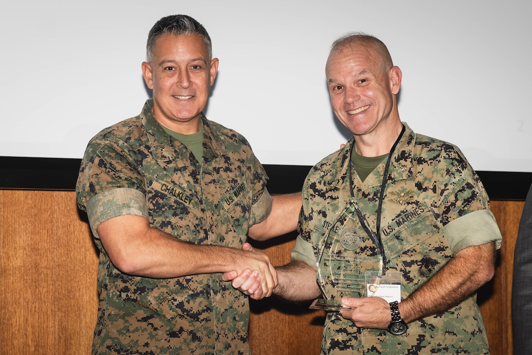 Lt. Col. Steele accepted the Von Steuben Superior Unit Performance Award on behalf of 2nd MAW for their outstanding performance during their Comprehensive Command Inspection, demonstrating high levels of efficiency, integrity, and institutional readiness and setting the standard for other units to emulate through their performance during an IGMC inspection. (U.S. Marine Corps photo by Cpl. Darien Wright)