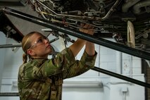 An Airmen works on a simulated C-17 Globemaster III engine