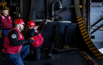 Sailors aboard USS Harry S. Truman (CVN 75) fire a shot line to USNS Arctic (T-AOE 8) during a replenishment-at-sea while participating in the NATO-led maritime vigilance activity Neptune Strike in the North Sea.