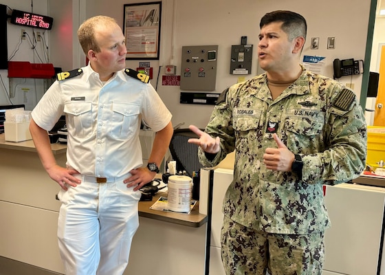 GUANTANAMO BAY, Cuba - Hospital Corpsman 1st Class Edinson Rosales, the Operational Forces Medical Liaison for U.S. Naval Hospital Guantanamo Bay, talks with Royal Netherlands Navy Lt. Jan-Peter Schaap during a tour of the hospital emergency department, Oct. 9, 2024. Schaap is a medical doctor aboard the HNMLS Holland (P840) and visited the hospital at U.S. Naval Station Guantanamo Bay during a scheduled visit to learn about hospital capabilities and the medical services provided. (U.S. Navy photo by Emily McCamy/released)