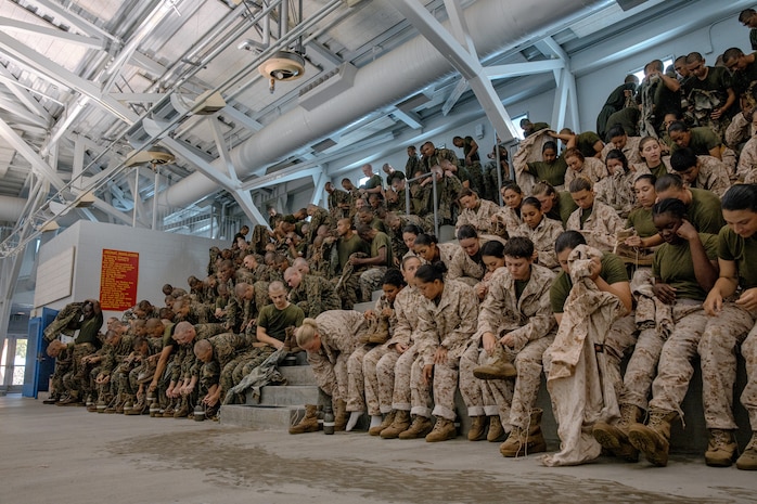 U.S. Marine Corps recruits with Fox Company, 2nd Recruit Training Battalion, prepare for a swim qualification event at Marine Corps Recruit Depot San Diego, California, Oct. 21, 2024. The basic swim qualification consists of a 25-meter swim, tower jump into the water, four-minute tread, 25-meter pack swim, and an underwater gear shed. (U.S. Marine Corps photo by Cpl. Sarah M. Grawcock)