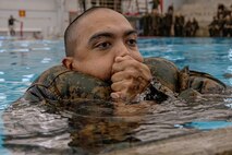 A U.S. Marine Corps recruit with Fox Company, 2nd Recruit Training Battalion, participates in a swim qualification event at Marine Corps Recruit Depot San Diego, California, Oct. 21, 2024. The basic swim qualification consists of a 25-meter swim, tower jump into the water, four-minute tread, 25-meter pack swim, and an underwater gear shed. (U.S. Marine Corps photo by Cpl. Sarah M. Grawcock)