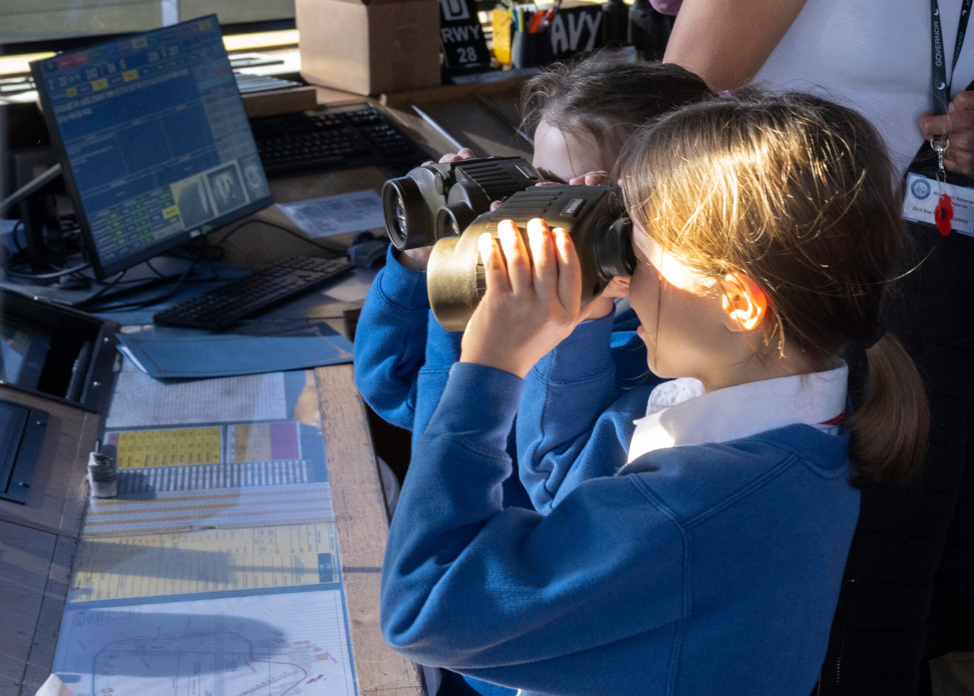 Competition winners use binoculars in the air traffic control tower at Royal Air Force Mildenhall, England, Oct. 17, 2024.