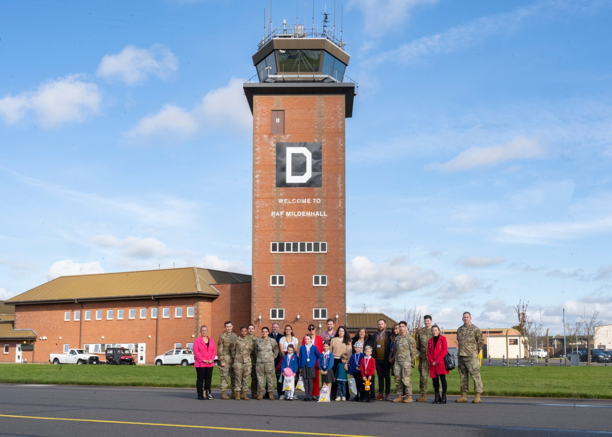 The 100th Civil Engineer Squadron firefighters, competition winners, guardians, and event leads pose for a group photograph at Royal Air Force Mildenhall, England, Oct. 17, 2024.