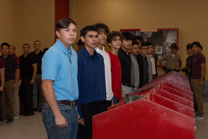 U.S. Marine Corps recruits with Lima Company, 3rd Recruit Training Battalion, are briefed during a receiving event at Marine Corps Recruit Depot San Diego, California, Oct. 21, 2024. During the receiving process, recruits are checked for contraband, given haircuts, make scripted phone calls home, and are issued gear required for training. (U.S. Marine Corps photo by Lance Cpl. Janell B. Alvarez)