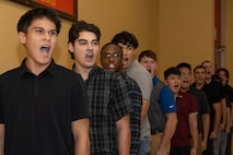 U.S. Marine Corps recruits with Lima Company, 3rd Recruit Training Battalion, are briefed during a receiving event at Marine Corps Recruit Depot San Diego, California, Oct. 21, 2024. During the receiving process, recruits are checked for contraband, given haircuts, make  scripted phone calls home, and are issued gear required for training. (U.S. Marine Corps photo by Lance Cpl. Janell B. Alvarez)