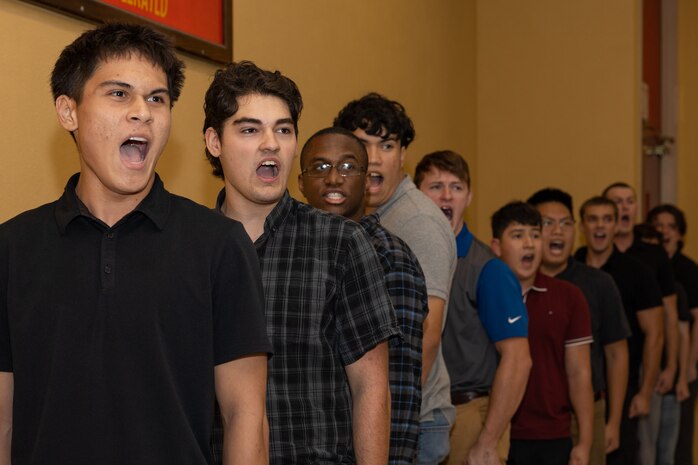U.S. Marine Corps recruits with Lima Company, 3rd Recruit Training Battalion, are briefed during a receiving event at Marine Corps Recruit Depot San Diego, California, Oct. 21, 2024. During the receiving process, recruits are checked for contraband, given haircuts, make  scripted phone calls home, and are issued gear required for training. (U.S. Marine Corps photo by Lance Cpl. Janell B. Alvarez)