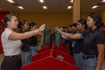 U.S. Marine Corps recruits with Lima Company, 3rd Recruit Training Battalion, are briefed during a receiving event at Marine Corps Recruit Depot San Diego, California, Oct. 21, 2024. During the receiving process, recruits are checked for contraband, given haircuts, make scripted phone calls home, and are issued gear required for training. (U.S. Marine Corps photo by Lance Cpl. Janell B. Alvarez)
