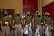 U.S. Marine Corps recruits with Lima Company, 3rd Recruit Training Battalion, are issued gear during a receiving event at Marine Corps Recruit Depot San Diego, California, Oct. 21, 2024. During the receiving process, recruits are checked for contraband, given haircuts, make scripted phone calls home, and are issued gear required for training. (U.S. Marine Corps photo by Lance Cpl. Janell B. Alvarez)