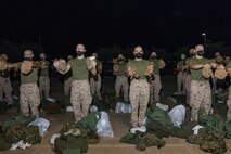 U.S. Marine Corps recruits with Lima Company, 3rd Recruit Training Battalion, are issued gear during a receiving event at Marine Corps Recruit Depot San Diego, California, Oct. 21, 2024. During the receiving process, recruits are checked for contraband, given haircuts, make scripted phone calls home, and are issued gear required for training. (U.S. Marine Corps photo by Lance Cpl. Janell B. Alvarez)