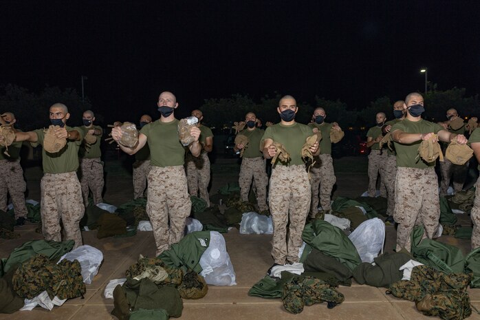 U.S. Marine Corps recruits with Lima Company, 3rd Recruit Training Battalion, are issued gear during a receiving event at Marine Corps Recruit Depot San Diego, California, Oct. 21, 2024. During the receiving process, recruits are checked for contraband, given haircuts, make scripted phone calls home, and are issued gear required for training. (U.S. Marine Corps photo by Lance Cpl. Janell B. Alvarez)