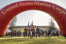 U.S. Marine Corps Lance Cpl. Bruno, the  Marine Corps Recruit Depot San Diego and Western Recruiting Region mascot, poses for a photo with Marines assigned to the Recruit Training Regiment Color Guard, MCRD San Diego, during the 2024 Marine Corps Recruit Depot San Diego Boot Camp Challenge at MCRD San Diego, California, Oct. 19, 2024. For the past 23 years, MCRD San Diego has hosted the Boot Camp Challenge, a three-mile obstacle course race guided by 60 drill instructors that highlights the physical and mental demands of bootcamp. The event fosters comradery and community engagement through interaction with MCRD personnel. (U.S. Marine Corps photo by Cpl. Sarah M. Grawcock)