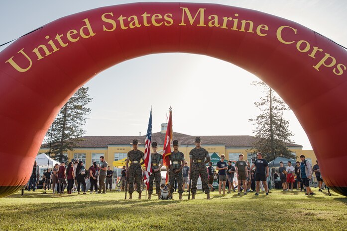 U.S. Marine Corps Lance Cpl. Bruno, the  Marine Corps Recruit Depot San Diego and Western Recruiting Region mascot, poses for a photo with Marines assigned to the Recruit Training Regiment Color Guard, MCRD San Diego, during the 2024 Marine Corps Recruit Depot San Diego Boot Camp Challenge at MCRD San Diego, California, Oct. 19, 2024. For the past 23 years, MCRD San Diego has hosted the Boot Camp Challenge, a three-mile obstacle course race guided by 60 drill instructors that highlights the physical and mental demands of bootcamp. The event fosters comradery and community engagement through interaction with MCRD personnel. (U.S. Marine Corps photo by Cpl. Sarah M. Grawcock)