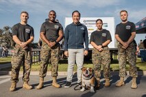 Todd Gloria, mayor of the city of San Diego, poses for a photo with U.S. Marine Corps Lance Cpl. Bruno, the  Marine Corps Recruit Depot San Diego and Western Recruiting Region mascot, and Marines with MCRD San Diego during the 2024 Marine Corps Recruit Depot San Diego Boot Camp Challenge at MCRD San Diego, California, Oct. 19, 2024. For the past 23 years, MCRD San Diego has hosted the Boot Camp Challenge, a three-mile obstacle course race guided by 60 drill instructors that highlights the physical and mental demands of bootcamp. The event fosters comradery and community engagement through interaction with MCRD personnel. (U.S. Marine Corps photo by Cpl. Sarah M. Grawcock)