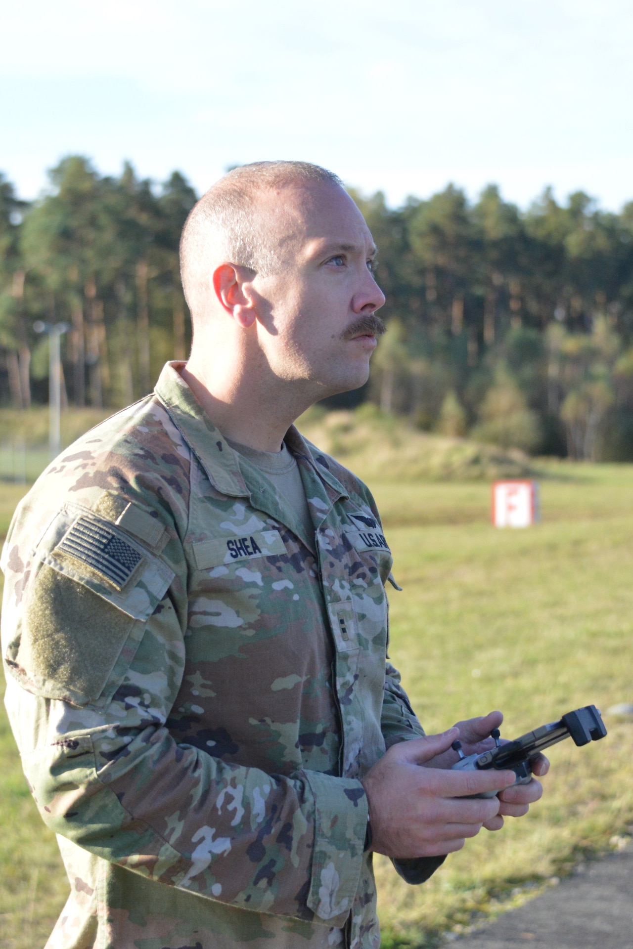 U.S. Army Chief Warrant Officer 2 Nathan Shea, assigned to Headquarters and Headquarters Company, 56th Stryker Brigade Combat Team, 28th Infantry Division, Pennsylvania National Guard maneuvers a drone during a test flight at Grafenwoehr Training Area, Germany, Oct. 11, 2024. Unmanned aircraft systems operators are required to have four hours of flight time each month to ensure their skills remain sharp and ready to meet the Army’s needs. (U.S. Army National Guard photo by Pfc. Israel Fernandez)
