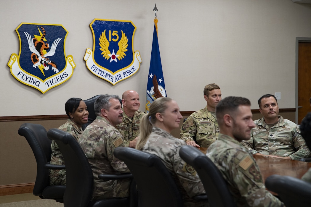 Airmen sit at a conference table