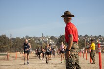 U.S. Marine Corps drill instructors with Recruit Training Regiment, encourage contestants during the 2024 Marine Corps Recruit Depot San Diego Boot Camp Challenge at MCRD San Diego, California, Oct. 19, 2024. For the past 23 years, MCRD San Diego has hosted the bootcamp Challenge, a three-mile obstacle course race guided by 60 drill instructors that highlights the physical and mental demands of bootcamp. The event fosters camaraderie and community engagement through interaction with MCRD personnel. (U.S. Marine Corps photo by Lance Cpl. Janell B. Alvarez)
