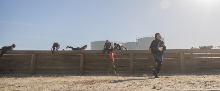 U.S. Marine Corps Sgt. Natasha Ajin, a drill instructor with Delta Company, 1st Recruit Training Battalion, encourages contestants during the 2024 Marine Corps Recruit Depot San Diego Boot Camp Challenge at MCRD San Diego, California, Oct. 19, 2024. For the past 23 years, MCRD San Diego has hosted the bootcamp Challenge, a three-mile obstacle course race guided by 60 drill instructors that highlights the physical and mental demands of bootcamp. The event fosters camaraderie and community engagement through interaction with MCRD personnel. (U.S. Marine Corps photo by Lance Cpl. Janell B. Alvarez)