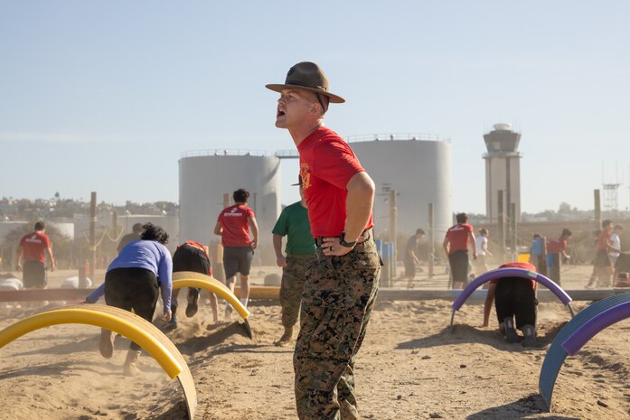 U.S. Marine Corps Staff Sgt. Drake L. Marten, a drill instructor with Charlie Company, 1st Recruit Training Battalion, encourages contestants during the 2024 Marine Corps Recruit Depot San Diego Boot Camp Challenge at MCRD San Diego, California, Oct. 19, 2024. For the past 23 years, MCRD San Diego has hosted the bootcamp Challenge, a three-mile obstacle course race guided by 60 drill instructors that highlights the physical and mental demands of bootcamp. The event fosters camaraderie and community engagement through interaction with MCRD personnel. (U.S. Marine Corps photo by Lance Cpl. Janell B. Alvarez)