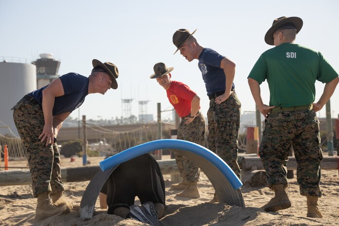 U.S. Marine Corps drill instructors with Recruit Training Regiment, encourage contestants during the 2024 Marine Corps Recruit Depot San Diego Boot Camp Challenge at MCRD San Diego, California, Oct. 19, 2024. For the past 23 years, MCRD San Diego has hosted the bootcamp Challenge, a three-mile obstacle course race guided by 60 drill instructors that highlights the physical and mental demands of bootcamp. The event fosters camaraderie and community engagement through interaction with MCRD personnel. (U.S. Marine Corps photo by Lance Cpl. Janell B. Alvarez)