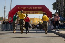 U.S. Marine Corps Staff Sgt. Jacob Anderson, right, a drill instructor with Support Battalion, Recruit Training Regiment, Sgt Brando J. Yanez and Sgt Kevin Gonzalez, both drill instructors with Golf Company, 2nd Recruit Training Battalion, encourage contestants during the 2024 Marine Corps Recruit Depot San Diego Boot Camp Challenge at MCRD San Diego, California, Oct. 19, 2024. For the past 23 years, MCRD San Diego has hosted the bootcamp Challenge, a three-mile obstacle course race guided by 60 drill instructors that highlights the physical and mental demands of bootcamp. The event fosters camaraderie and community engagement through interaction with MCRD personnel. (U.S. Marine Corps photo by Lance Cpl. Janell B. Alvarez)