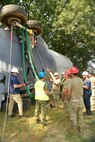 Experienced aircraft recovery personnel from around the world, including participants from the U.S. Air Force, Navy, and Marines, as well as teams from five F-35 foreign partner countries, practice aircraft crane lift-rollover procedures on a C-130 training aircraft Sept. 11, 2024, at Volk Field Air National Guard Base, WI. This training, organized by the F-35 Joint Program Office, aimed to share techniques and methodologies, and build international relationships during the advanced CDDAR training exercise for the F-35 global enterprise. (U.S. Air Force photo by Todd Cromar)
