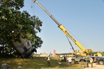 Experienced aircraft recovery personnel from around the world, including participants from the U.S. Air Force, Navy, and Marines, as well as teams from five F-35 foreign partner countries, practice aircraft crane lift-rollover procedures on a C-130 training aircraft Sept. 11, 2024, at Volk Field Air National Guard Base, WI. This training, organized by the F-35 Joint Program Office, aimed to share techniques and methodologies, and build international relationships during the advanced CDDAR training exercise for the F-35 global enterprise. (U.S. Air Force photo by Todd Cromar)