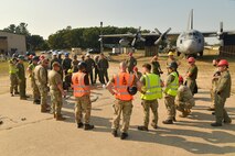 Experienced aircraft recovery personnel from around the world, including participants from the U.S. Air Force, Navy, and Marines, as well as teams from five F-35 foreign partner countries, hotwash after successfully completing airbag-lift procedures on a C-130 training aircraft Sept. 12, 2024, at Volk Field Air National Guard Base, WI. This training, organized by the F-35 Joint Program Office, aimed to share techniques and methodologies, and build international relationships during the advanced CDDAR training exercise for the F-35 global enterprise. (U.S. Air Force photo by Todd Cromar)