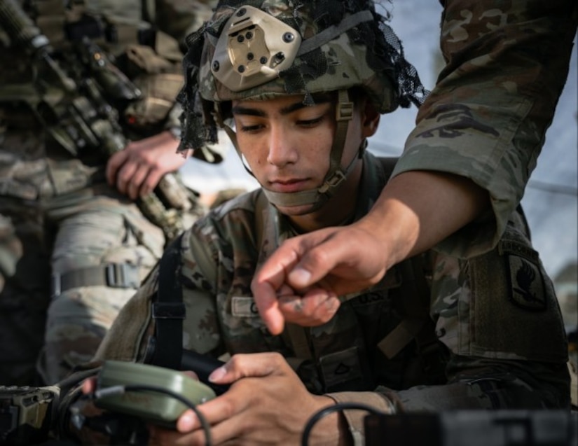 Soldiers sit while training.