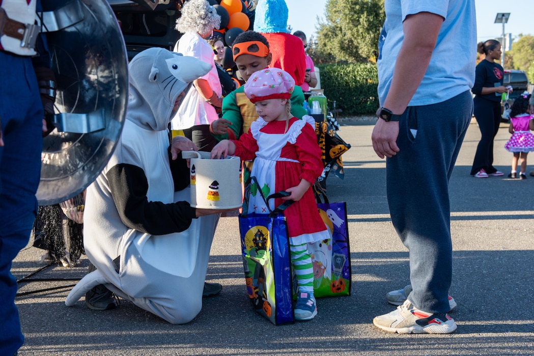 Volunteer handing out candy to children