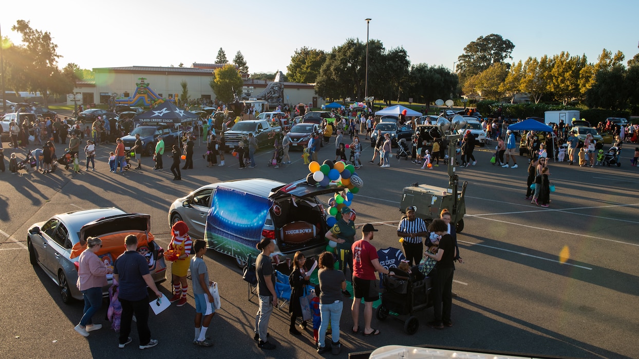 Overall view of families and decorated trucks for Halloween event