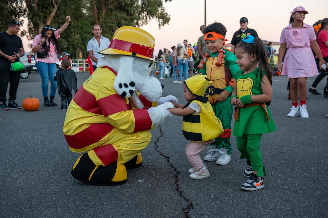 Fire safety mascot dancing with children