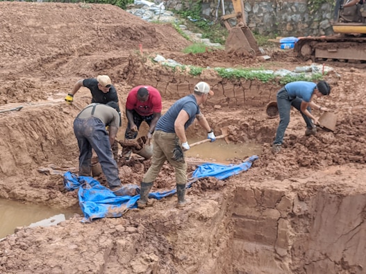 Team members from the Defense POW/MIA Accounting Agency collect and move soil to be screened while searching for potential remains from a suspected P-40 Warhawk that crashed in 1943 in the Hunan province of China, September 9. 2024.