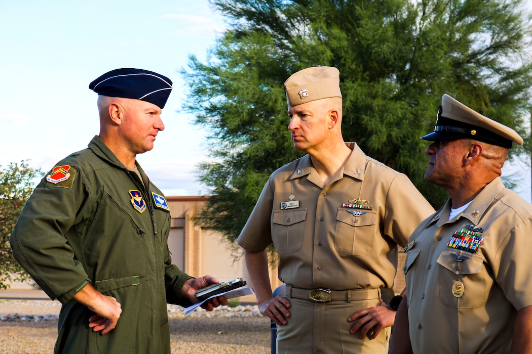 U.S. Air Force Brig. Gen. David Berkland, 56th Fighter Wing commander, speaks with U.S. Navy Capt. Christopher Seely, Navy Reserve Center Phoenix commanding officer, and Master Chief Juan Ramirez, NRC Phoenix command master chief, before the Retiree Appreciation Day event, Oct. 19, 2024, at Luke Air Force Base, Arizona.