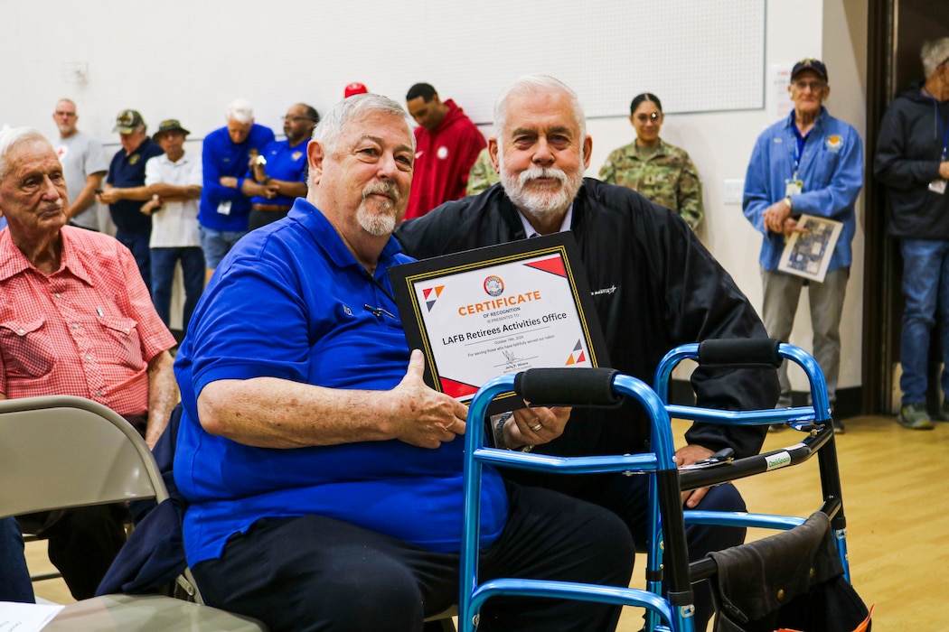 Jerry P. Weiers, Glendale mayor (right), presents a certificate of recognition to W. D. Moore, Retiree Activities Office director, at the Retiree Appreciation Day event, Oct. 19, 2024, at Luke Air Force Base, Arizona.