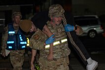 An Airman carries a simulated casualty on his shoulders