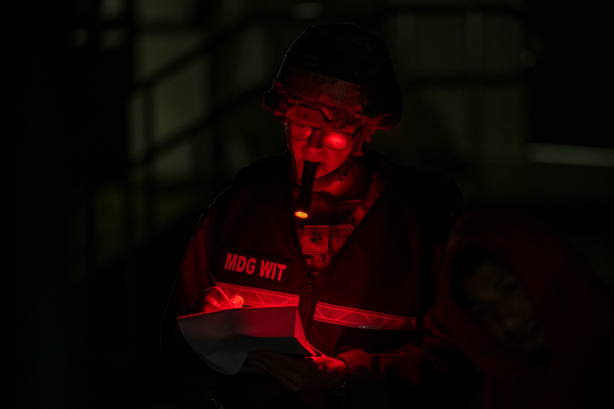 WIT member uses flashlight to take notes