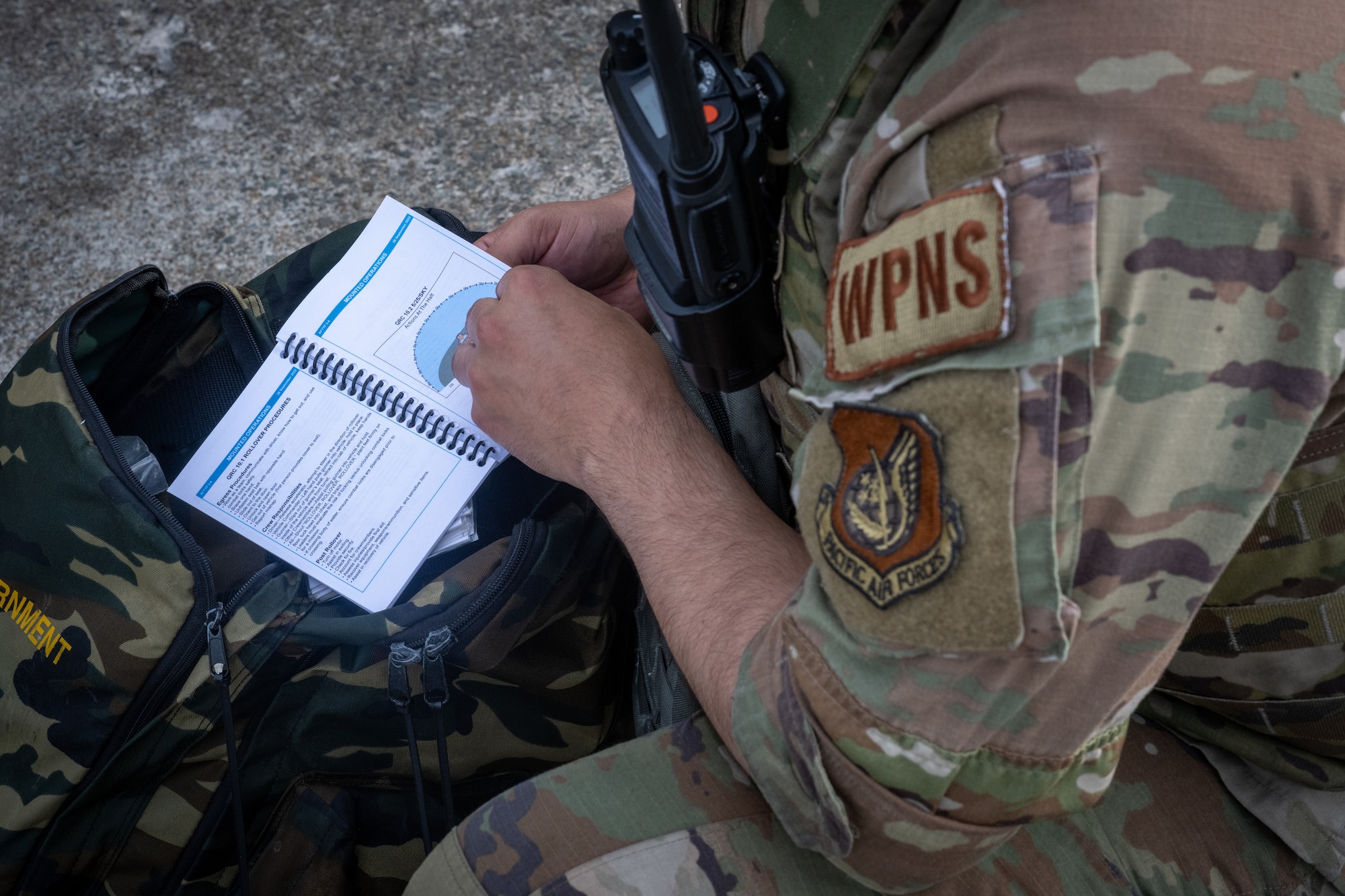 Airmen look at Airman's Manual