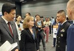 U.S. Navy Cmdr. Thomas Miyano (right), Defense Contract Management Agency Pacific’s commander, speaks with Japan's Minister of Defense, Minoru Kihara (left), and U.S. Deputy Chief of Mission to Japan Katherine Monahan (center), during Japan’s Ministry of Defenses Industry Day, Sept. 26, 2024.