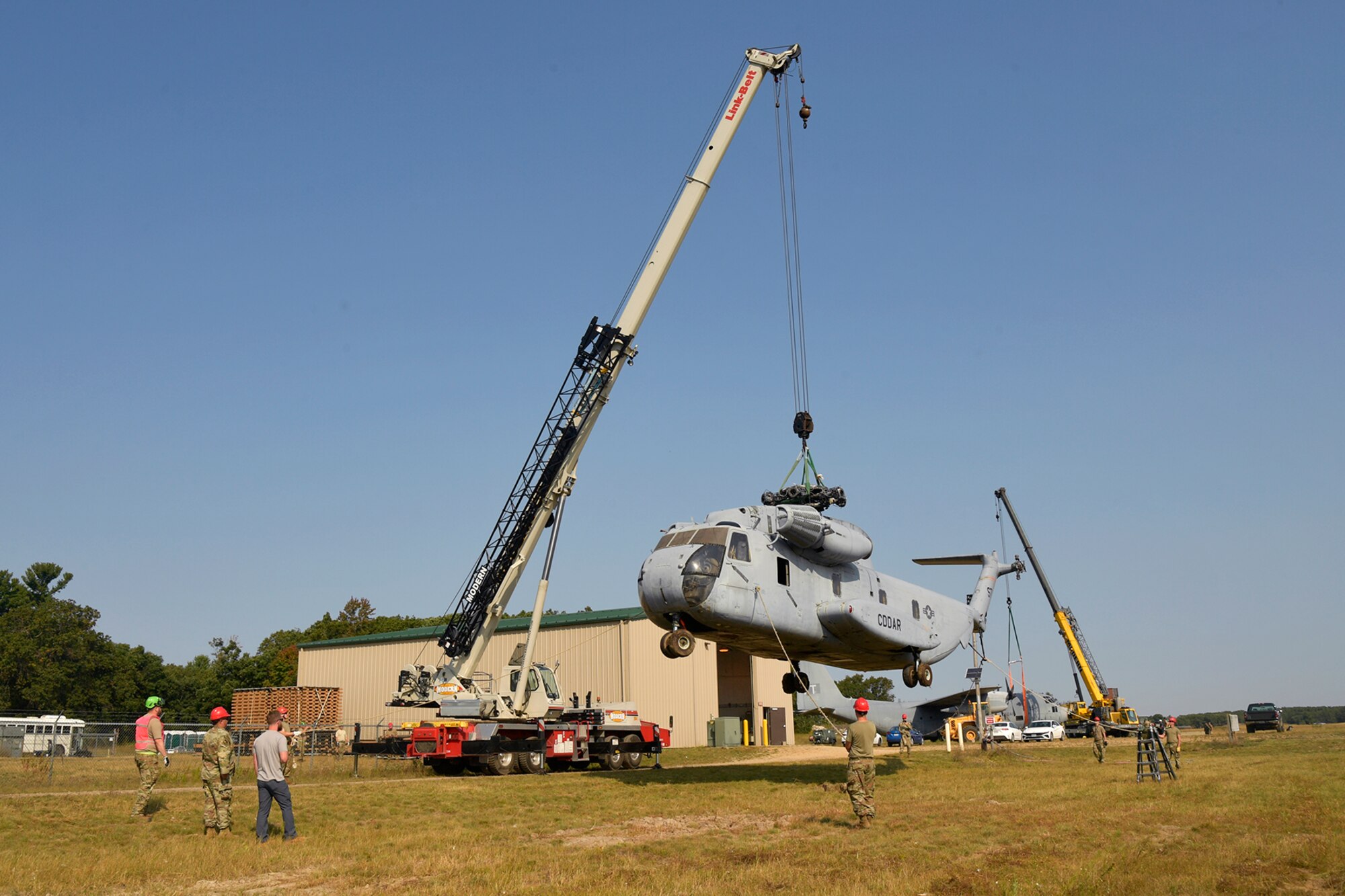 Experienced aircraft recovery personnel from around the world, including participants from the U.S. Air Force, Navy, and Marines, as well as teams from five F-35 foreign partner countries, practice aircraft lift procedures on a CH-53 helicopter training aircraft Sept. 11, 2024, at Volk Field Air National Guard Base, WI. This training, organized by the F-35 Joint Program Office, aimed to share techniques and methodologies, and build international relationships during the advanced CDDAR training exercise for the F-35 global enterprise. (U.S. Air Force photo by Todd Cromar)