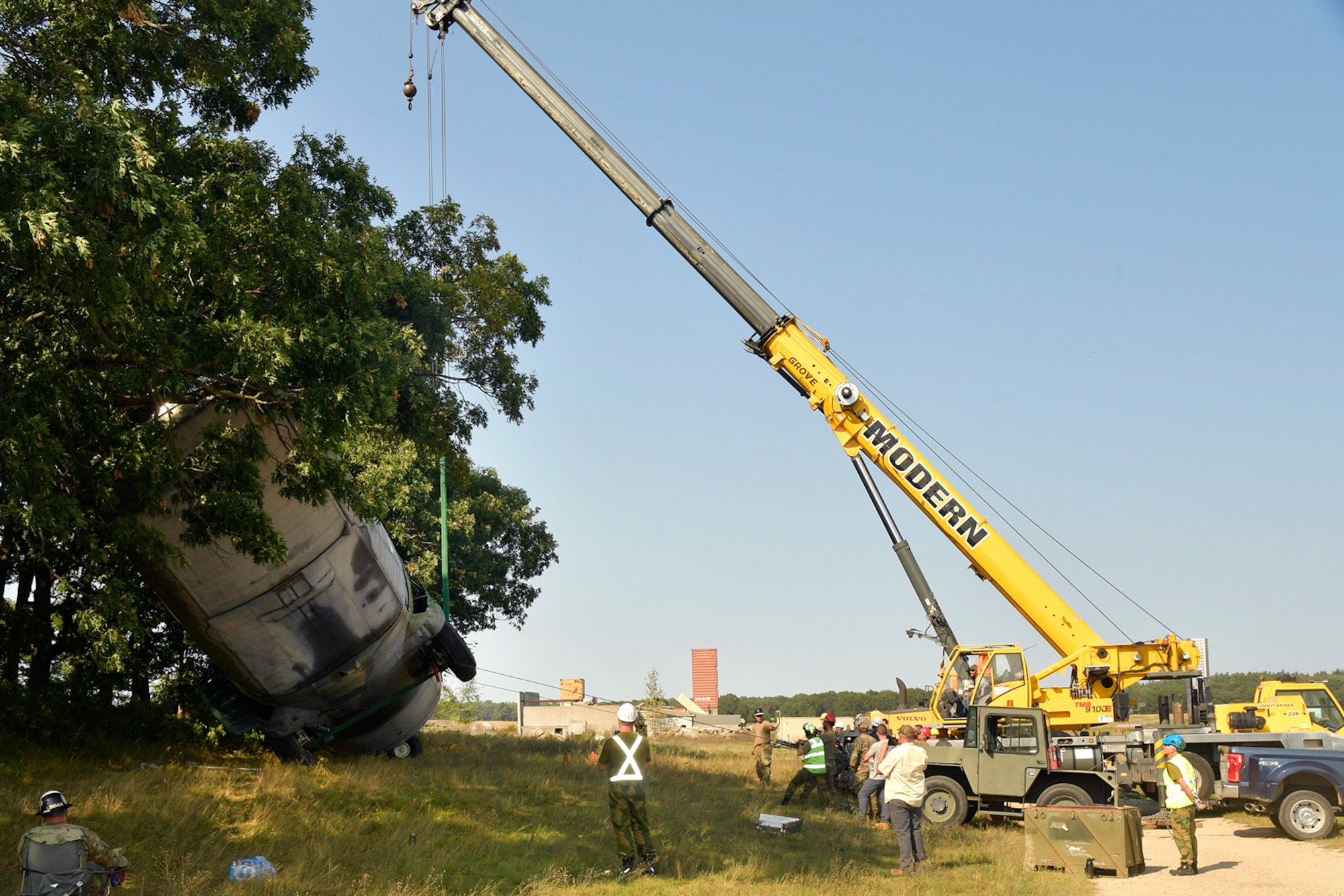 Experienced aircraft recovery personnel from around the world, including participants from the U.S. Air Force, Navy, and Marines, as well as teams from five F-35 foreign partner countries, practice aircraft crane lift-rollover procedures on a C-130 training aircraft Sept. 11, 2024, at Volk Field Air National Guard Base, WI. This training, organized by the F-35 Joint Program Office, aimed to share techniques and methodologies, and build international relationships during the advanced CDDAR training exercise for the F-35 global enterprise. (U.S. Air Force photo by Todd Cromar)
