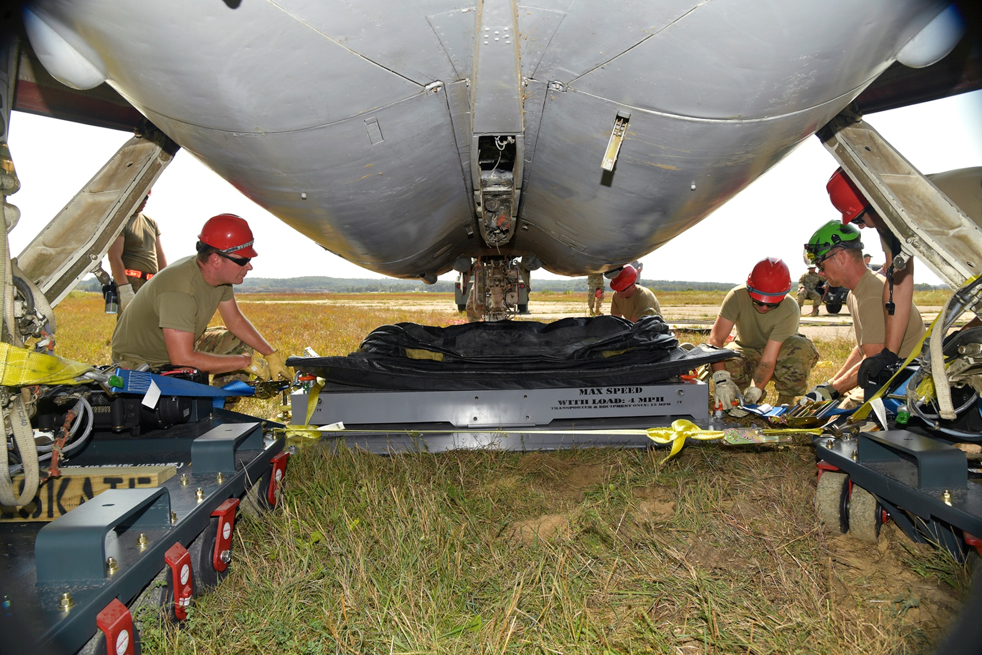 Experienced aircraft recovery personnel from around the world, including participants from the U.S. Air Force, Navy, and Marines, as well as teams from five F-35 foreign partner countries, practice aircraft drag-recovery procedures on an A-6 training aircraft Sept. 11, 2024, at Volk Field Air National Guard Base, WI. This training, organized by the F-35 Joint Program Office, aimed to share techniques and methodologies, and build international relationships during the advanced CDDAR training exercise for the F-35 global enterprise. (U.S. Air Force photo by Todd Cromar)