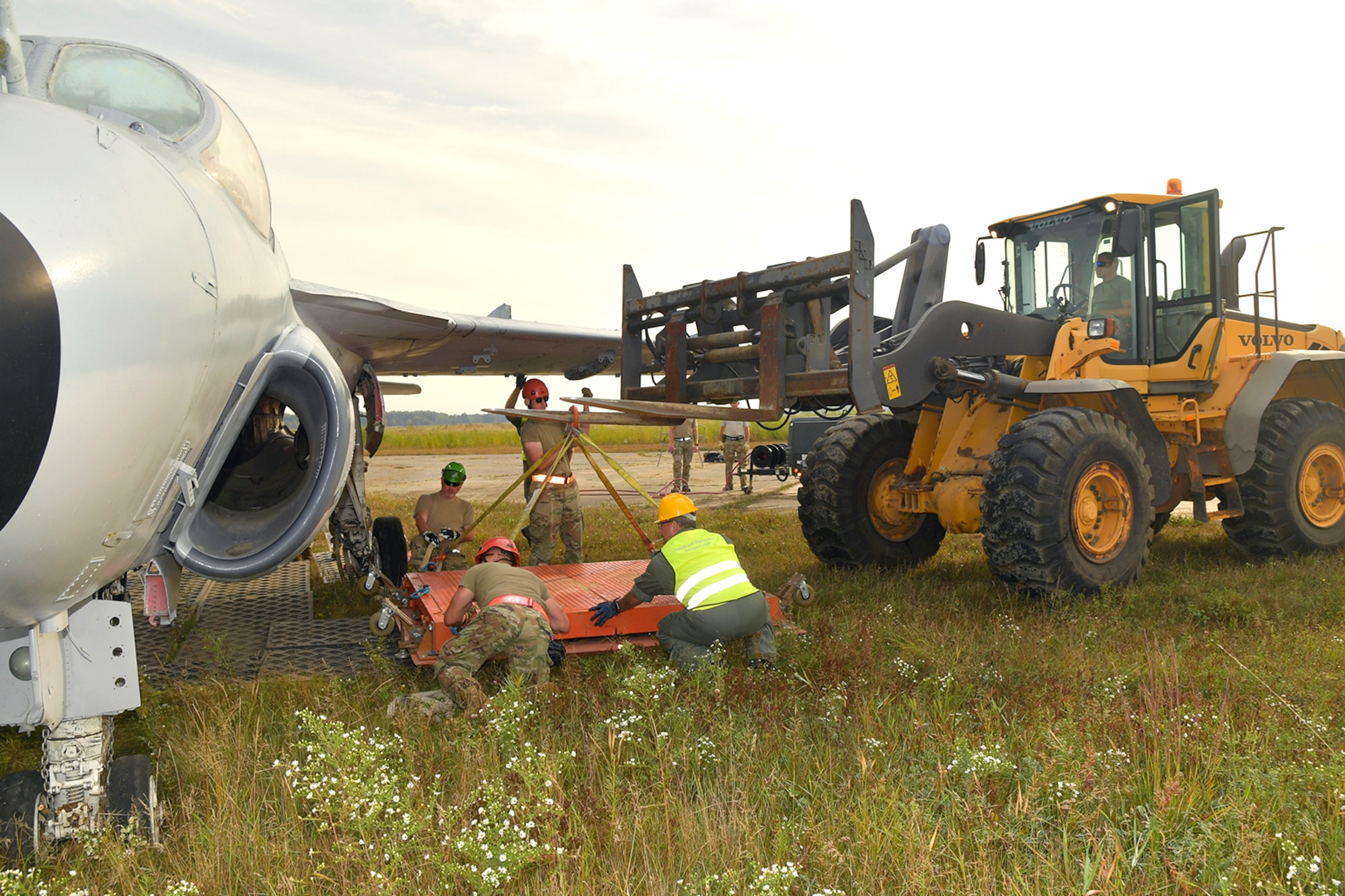 Air Force members recover disabled F-16 with 10k forklift at Volk Field during CDDAR Training.