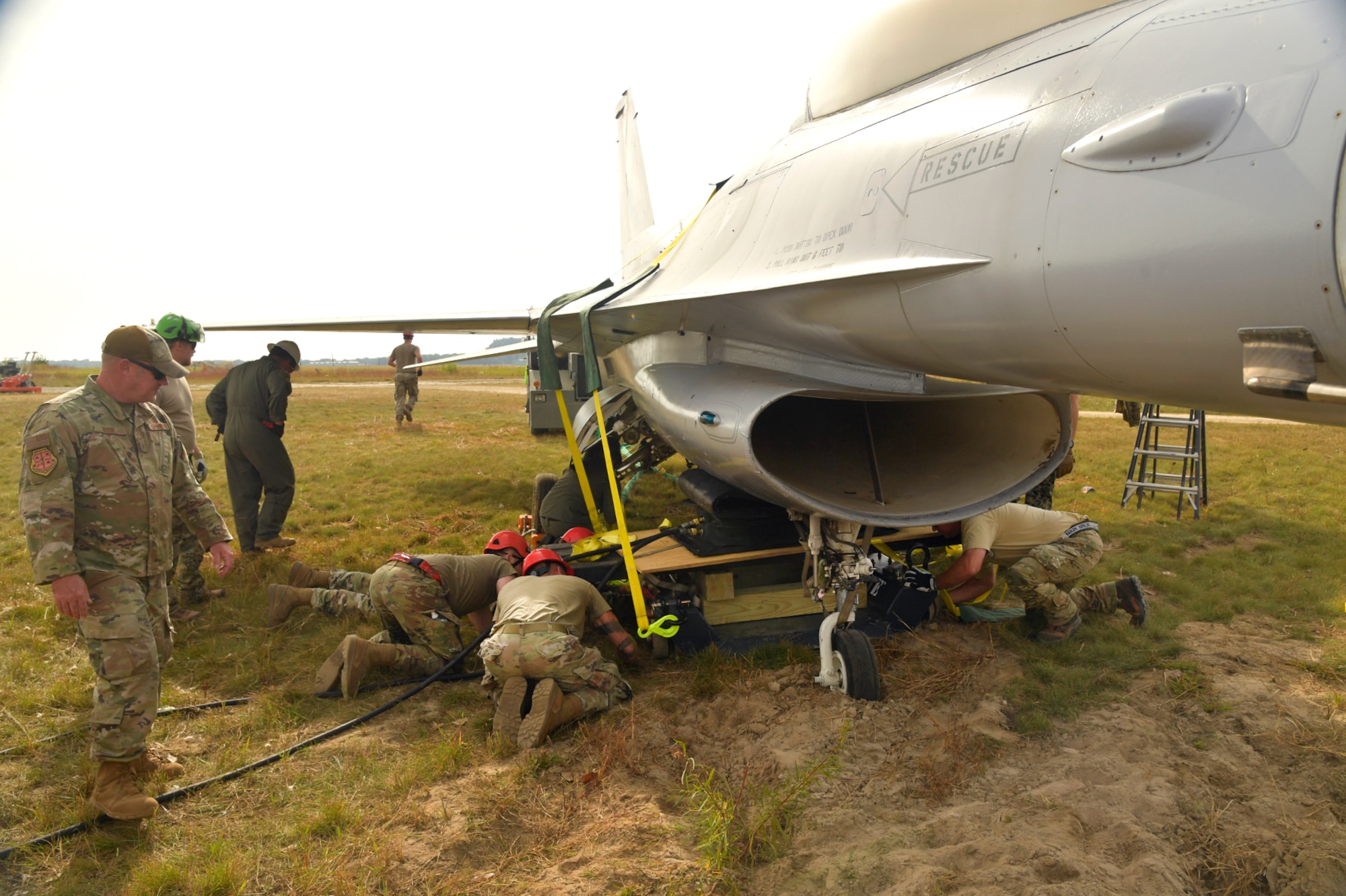 Experienced aircraft recovery personnel from around the world, including participants from the U.S. Air Force, Navy, and Marines, as well as teams from five F-35 foreign partner countries, practice airbag-lift-drag recovery procedures on an F-16A training aircraft Sept. 13, 2024, at Volk Field Air National Guard Base, WI. This training, organized by the F-35 Joint Program Office, aimed to share techniques and methodologies, and build international relationships during the advanced CDDAR training exercise for the F-35 global enterprise. (U.S. Air Force photo by Todd Cromar)