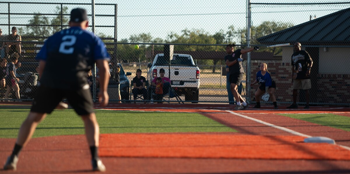 King Gentles, 17th Civil Engineering Squadron firefighter, hits the ball at the home plate during the Inaugural Battle of the Badges softball game at the Mathis Fitness Center at Goodfellow Air Force Base Texas, Oct. 28, 2024. Battle of the Badges is an annual event for first responders to compete with one another while raising awareness of the importance of blood donation. (U.S. Air Force photo by Airman 1st Class Brian Lummus)