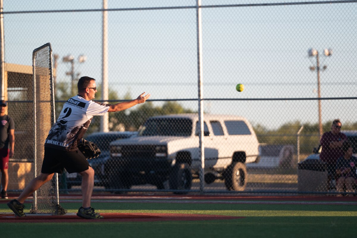 Christopher Wright, 17th Security Forces Squadron pitcher, throws a softball during the Inaugural Battle of the Badges softball game at the Mathis Fitness Center at Goodfellow Air Force Base Texas, Oct. 28, 2024. The 17th SFS won the softball game with a score of 16-8. (U.S. Air Force photo by Airman 1st Class Brian Lummus)