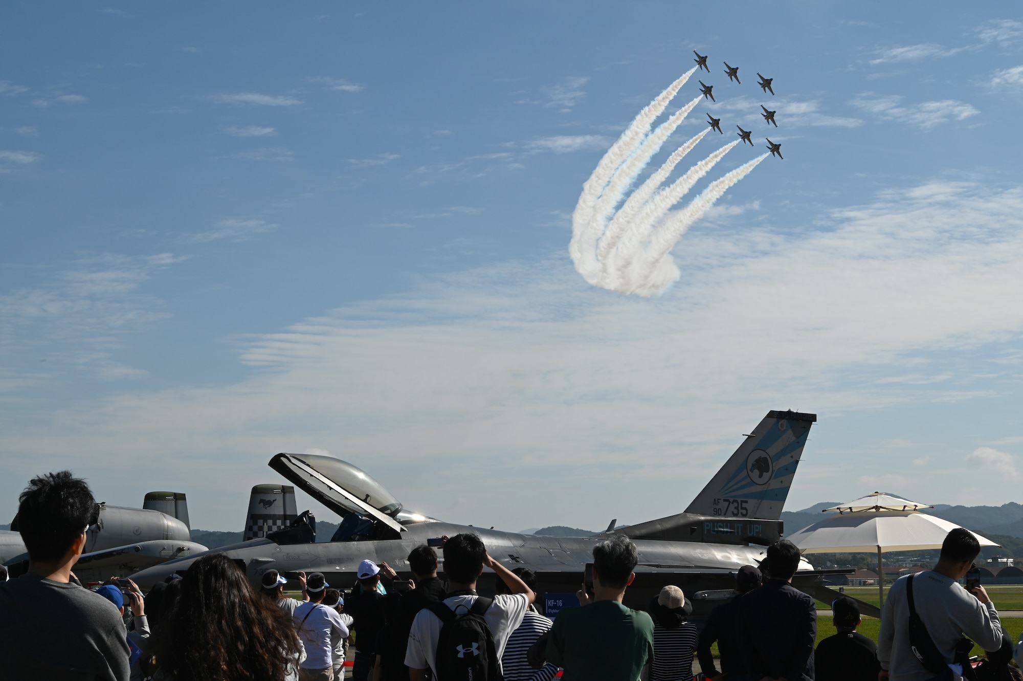 The Republic of Korea Air Force’s Black Eagles perform an aerial maneuver as an F-16 Fighting Falcon sits in the foreground during the Sacheon Airshow 2024 in Gyeongnam, Republic of Korea, Oct. 26, 2024. Seventh Air Force provided an F-16 Fighting Falcon and A-10 Thunderbolt II aircraft for static displays, and participated in daily combat search and rescue demonstrations with two A-10 aircraft. (U.S. Air Force photo by Master Sgt. Rachelle Coleman)