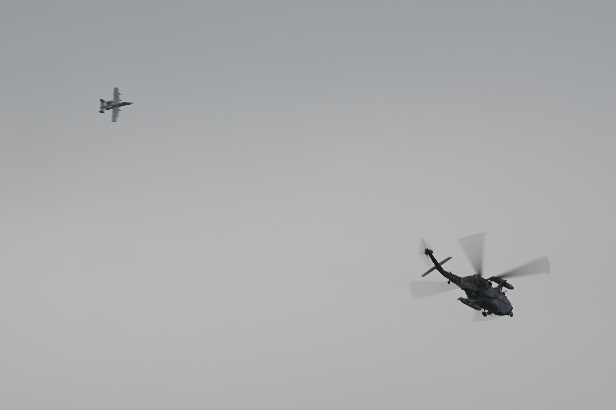 An A-10 Thunderbolt II flys above a helicopter in a combat search and rescue demonstration during the Sacheon Airshow 2024 in Gyeongnam, Republic of Korea, Oct. 27, 2024. Seventh Air Force provided an F-16 Fighting Falcon and A-10 Thunderbolt II aircraft for static displays, and participated in daily combat search and rescue demonstrations with two A-10 aircraft. (U.S. Air Force photo by Master Sgt. Rachelle Coleman)